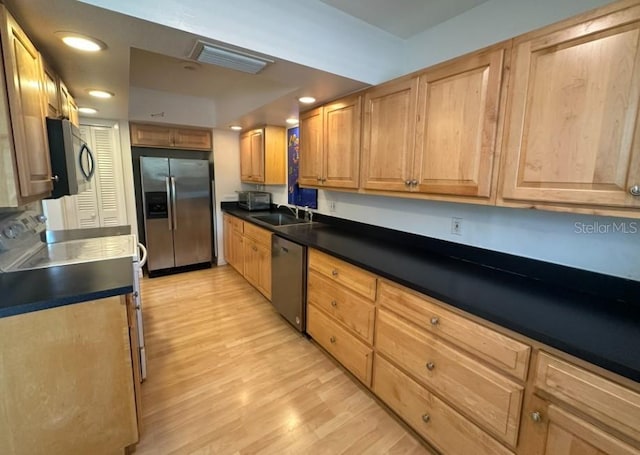 kitchen featuring sink, stainless steel appliances, and light hardwood / wood-style floors