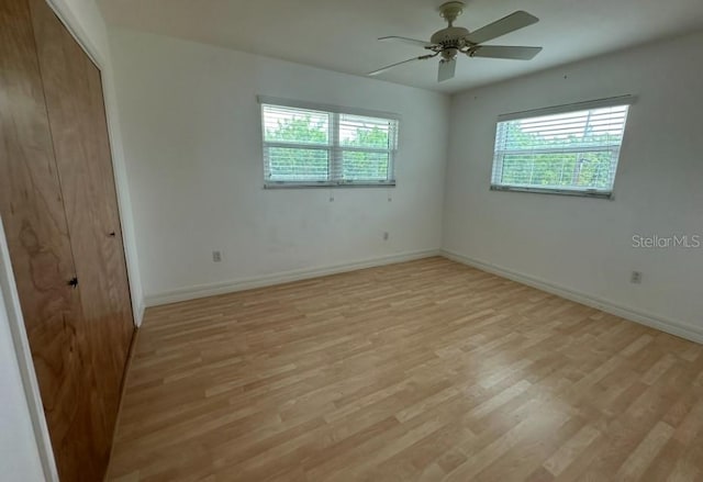 spare room featuring ceiling fan and light hardwood / wood-style flooring