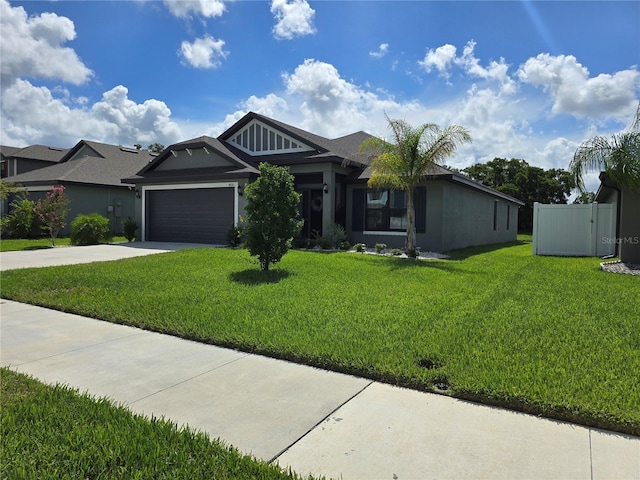 view of front of house featuring a garage and a front lawn