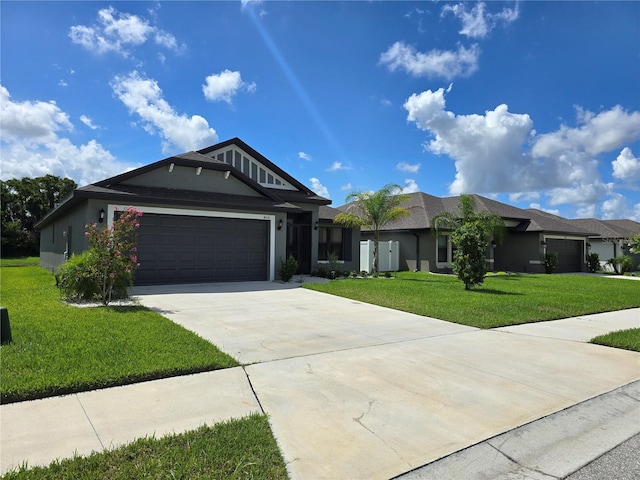 view of front of home with a garage and a front lawn