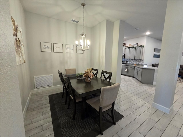 dining area with an inviting chandelier