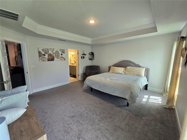 carpeted bedroom with crown molding, connected bathroom, and a tray ceiling