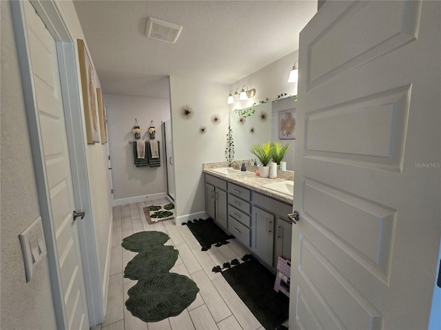 bathroom with vanity and a textured ceiling