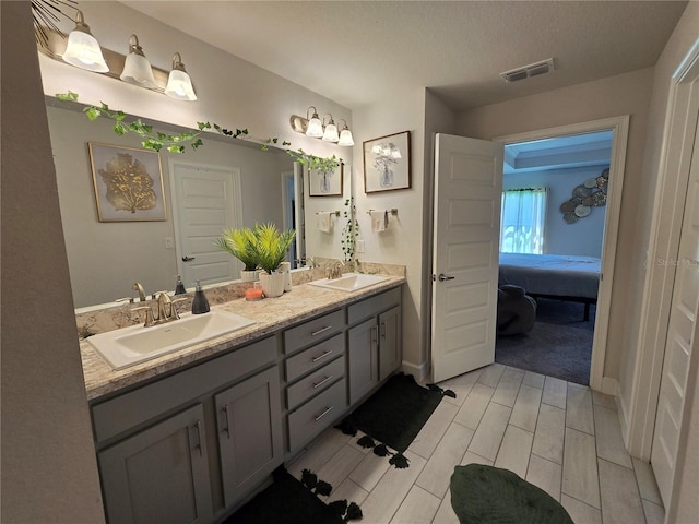 bathroom featuring vanity and a textured ceiling