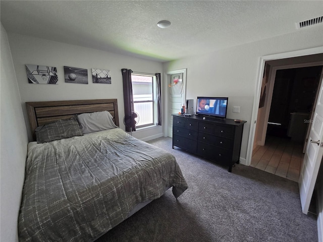 carpeted bedroom with a textured ceiling