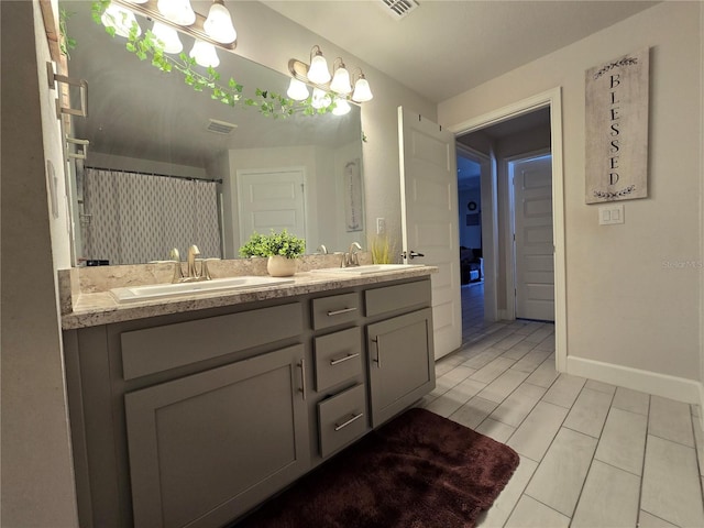 bathroom with vanity, curtained shower, and tile patterned floors