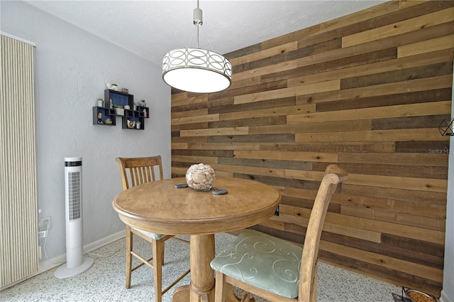 dining area featuring wooden walls