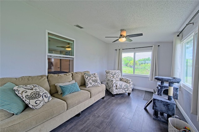 living room featuring a textured ceiling and dark wood-type flooring