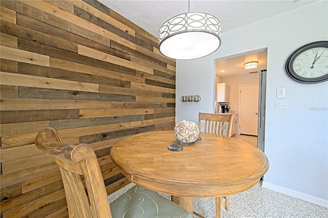 dining space featuring wooden walls