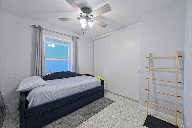 bedroom featuring ceiling fan and a closet