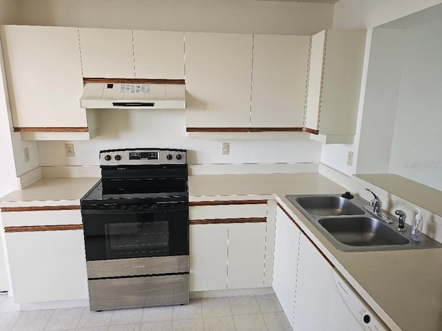 kitchen with white cabinets, sink, light tile patterned flooring, and stainless steel electric range