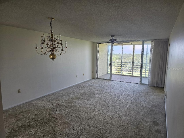 spare room featuring ceiling fan with notable chandelier, floor to ceiling windows, a textured ceiling, and carpet