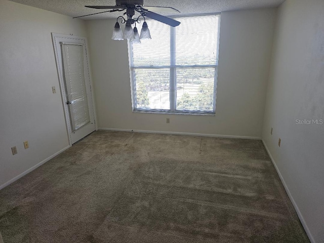 spare room featuring ceiling fan, a textured ceiling, and carpet floors