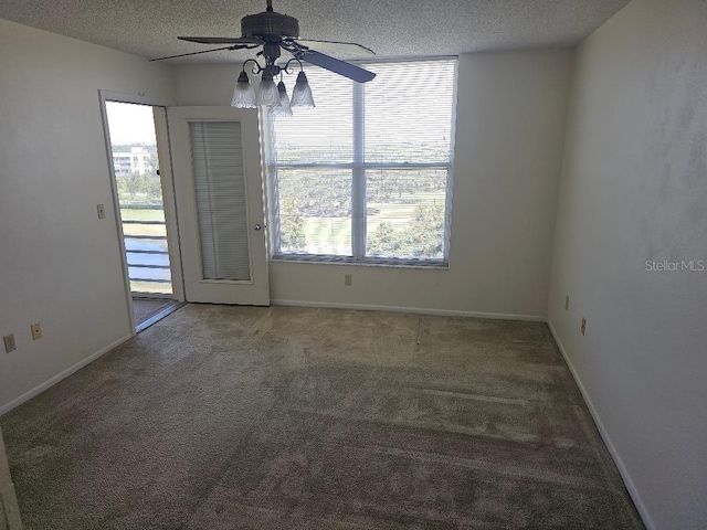 spare room featuring a textured ceiling, ceiling fan, and carpet floors