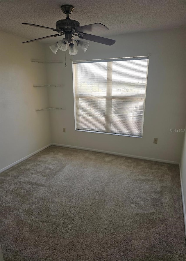 4410 Fairways Blvd Unit 602, Bradenton, FL 34209 - carpeted empty room with a textured ceiling, healthy amount of natural light, ceiling fan, and baseboards