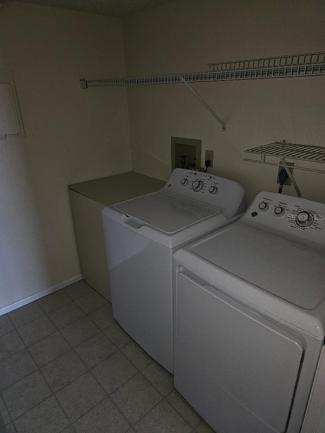 laundry room with light tile patterned floors and separate washer and dryer