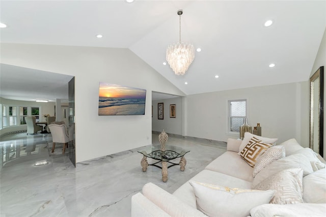 living room with a chandelier and vaulted ceiling