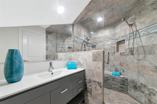 bathroom featuring vanity and a shower with door