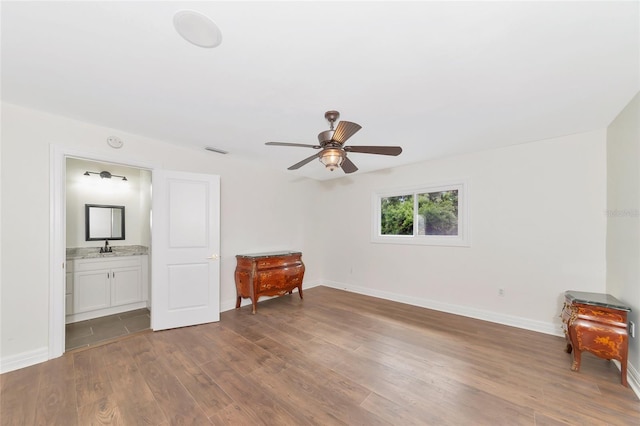 interior space with ceiling fan, sink, and dark wood-type flooring