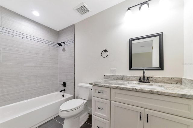 full bathroom featuring tile patterned floors, vanity, toilet, and tiled shower / bath