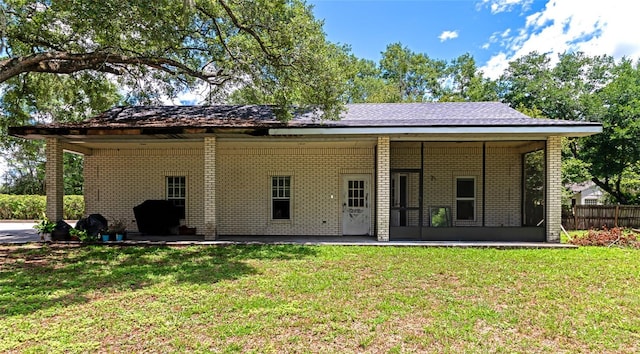 back of house with a lawn