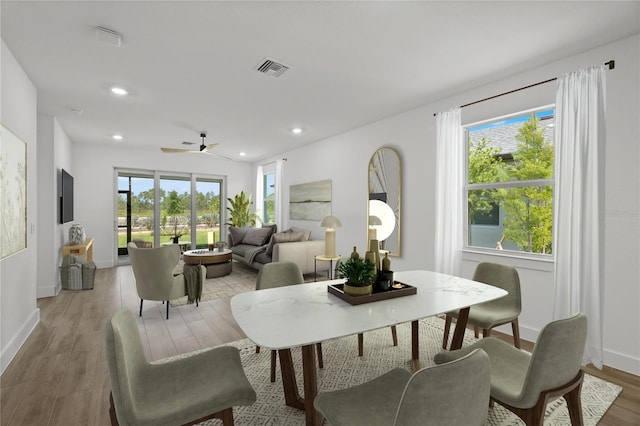 dining room featuring hardwood / wood-style floors, ceiling fan, and a healthy amount of sunlight