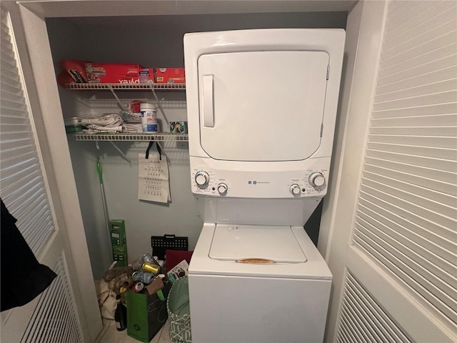 washroom featuring stacked washer / drying machine