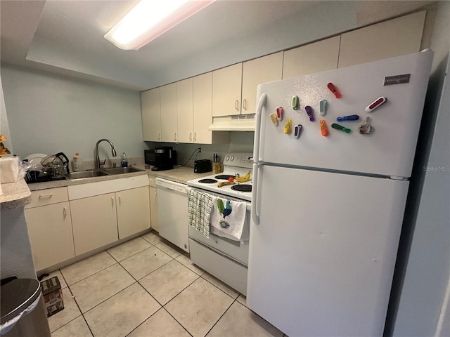 kitchen featuring white appliances, sink, and light tile patterned floors