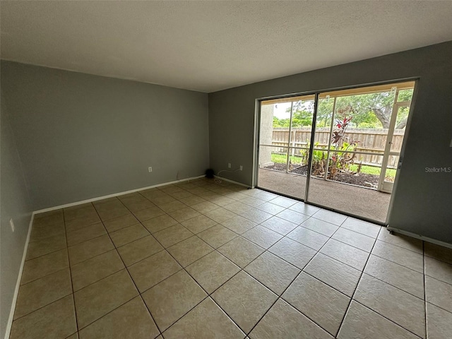 tiled spare room with a textured ceiling