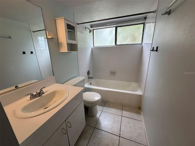 full bathroom featuring vanity, tile patterned flooring, tiled shower / bath combo, and toilet