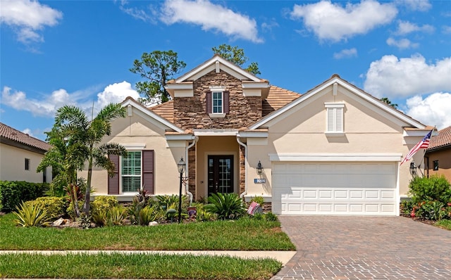 view of property with a garage and a front yard