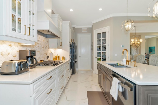 kitchen featuring a kitchen island with sink, sink, custom range hood, appliances with stainless steel finishes, and white cabinetry