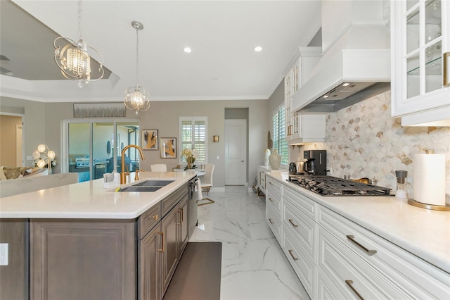 kitchen with premium range hood, decorative backsplash, white cabinets, and stainless steel appliances