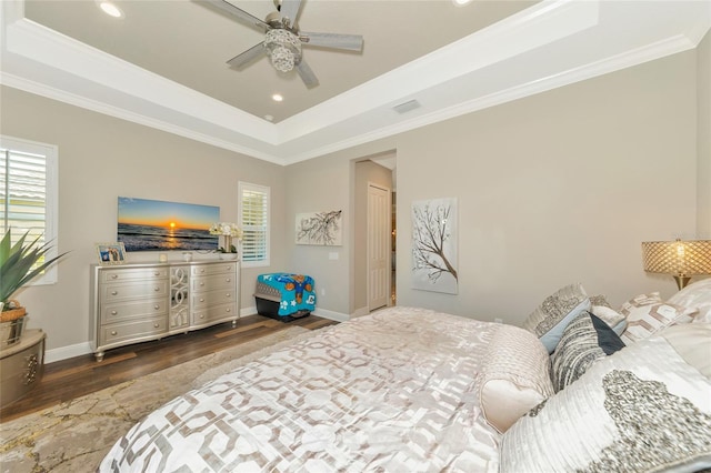 bedroom featuring a raised ceiling, ceiling fan, and ornamental molding