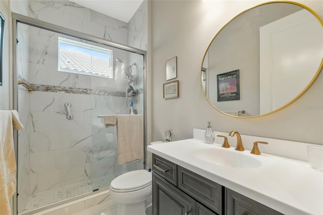 bathroom with a shower with door, vanity, and toilet