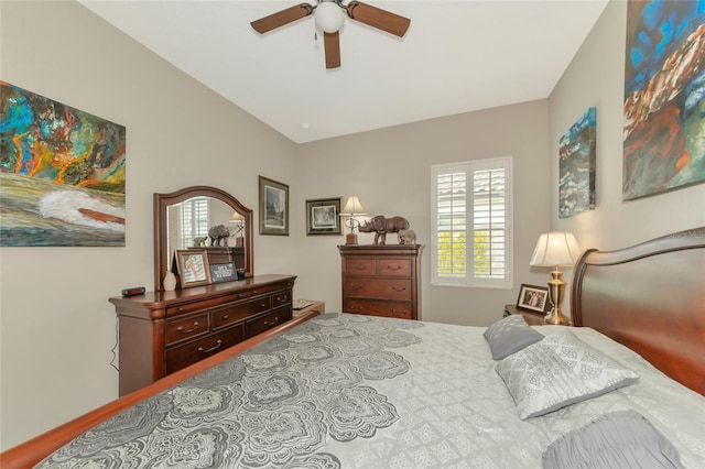 bedroom featuring multiple windows, ceiling fan, and vaulted ceiling