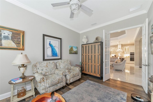 living room featuring ceiling fan, ornamental molding, and french doors