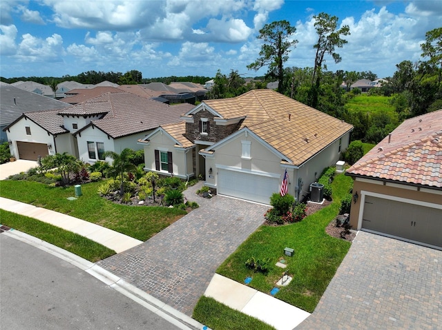 view of front of house with central AC and a front lawn