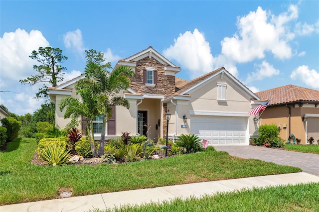 view of front of house featuring a front lawn and a garage