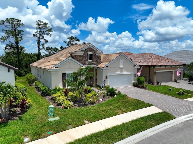 view of front of property with a front yard and a garage