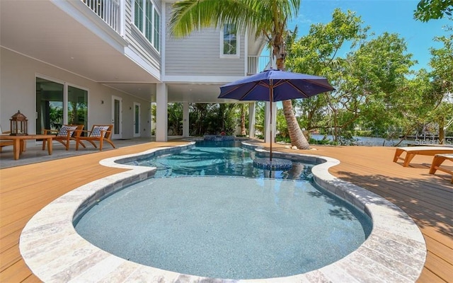 view of swimming pool with a deck