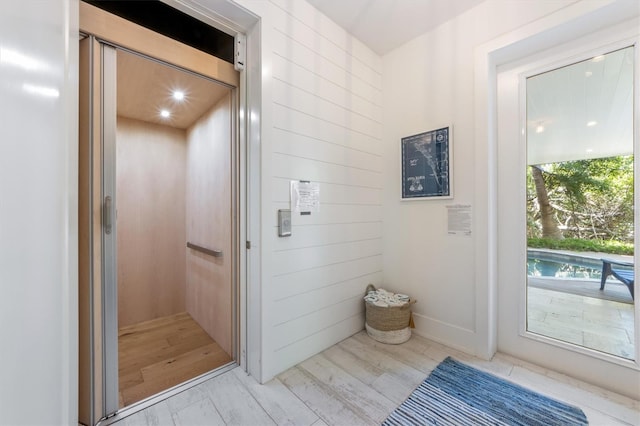 bathroom featuring elevator and hardwood / wood-style floors