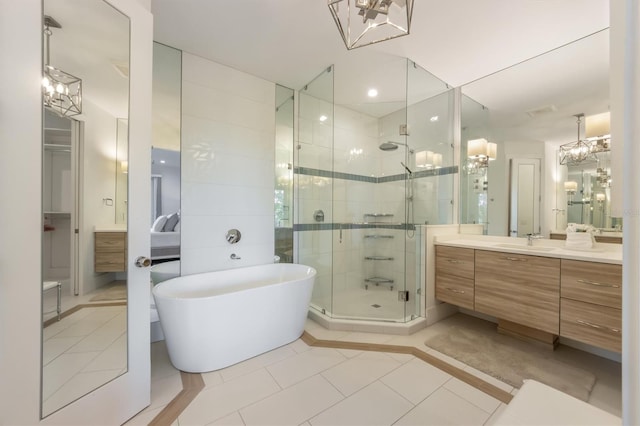 bathroom featuring vanity, plus walk in shower, and tile patterned flooring