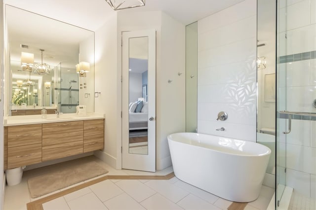 bathroom with shower with separate bathtub, vanity, tile patterned flooring, and an inviting chandelier