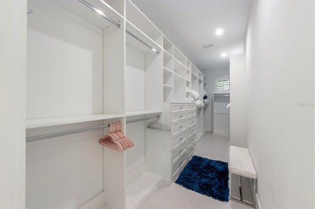 spacious closet with light tile patterned floors