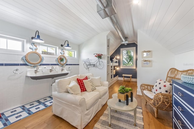 interior space featuring light wood-type flooring, wooden ceiling, and lofted ceiling with beams