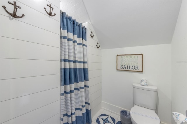 bathroom featuring tile patterned floors, vaulted ceiling, and toilet