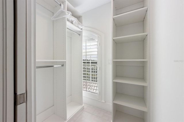 spacious closet featuring light tile patterned floors