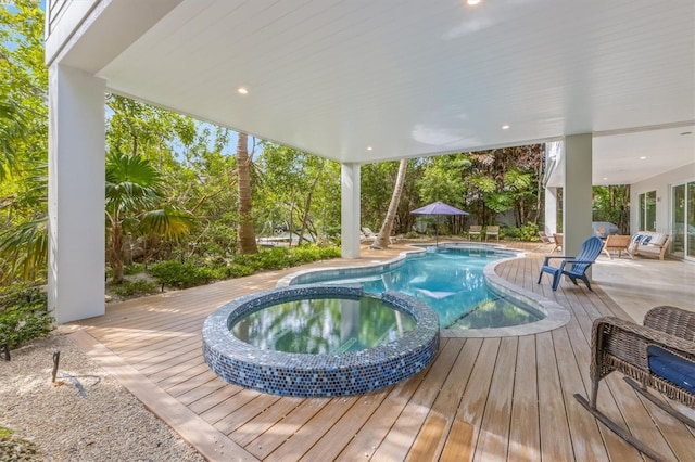 view of swimming pool with an in ground hot tub and a wooden deck