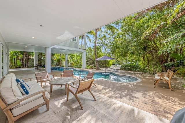 view of pool featuring a patio and a wooden deck